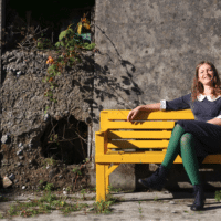 Claudia Schwab on a bench by Peter Crann